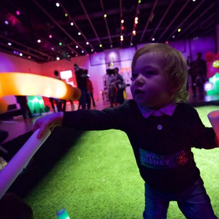 Child Experiencing Immersive Light Installation at Baby Rave