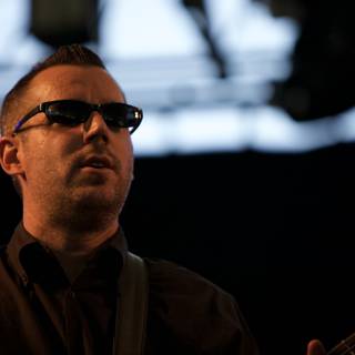 Man in sunglasses rocking out on stage