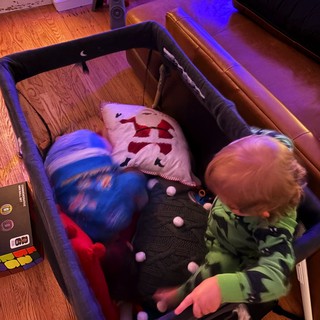 Toddler Playing with Toys in Pack 'n Play at Home