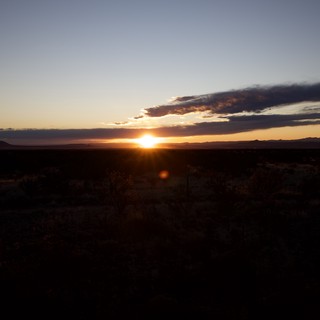 Desert Sunset Over Distant Mountain Ranges