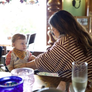 Mother and Child Sharing Mealtime at Restaurant Table