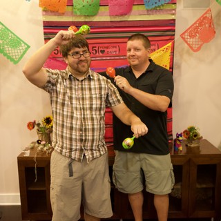 Two Friends Celebrate with Maracas at Fiesta Party