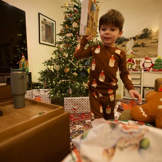 Child Opening Christmas Presents on Christmas Morning