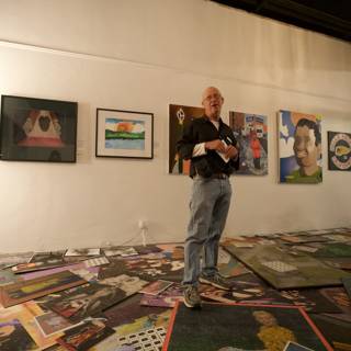 Man Admiring Paintings on Gallery Floor