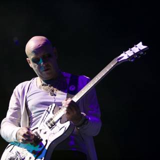 Rocking the Stage: Bald Man Shredding on Electric Guitar