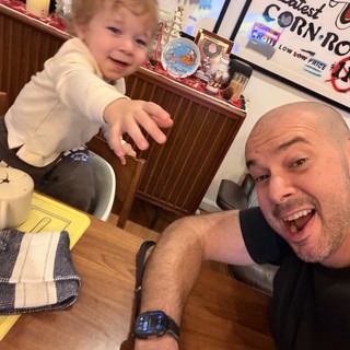 Father and Toddler Selfie at Festive Dining Table