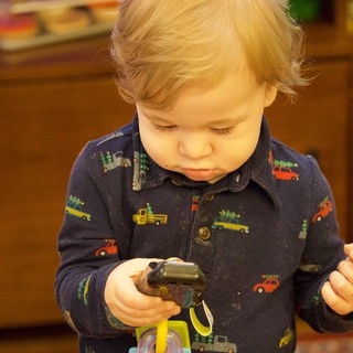 Toddler Playing with Toy Trucks on Christmas Eve