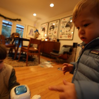 Young Child Playing with Toy Robot at Home