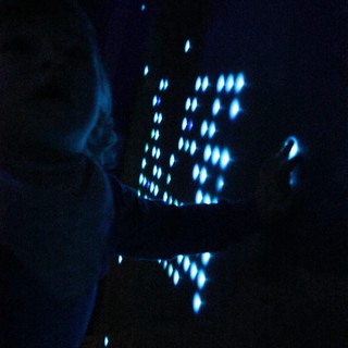 Blue Illuminated Perforated Pattern in Darkness