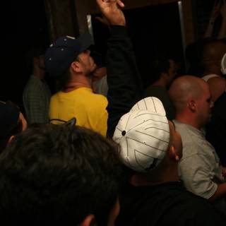 Partygoers Celebrate the End of Summer with Baseball Caps