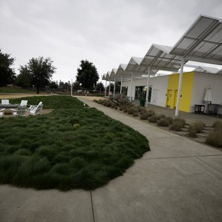Modern Pavilion with Zigzag Roofline and Outdoor Seating