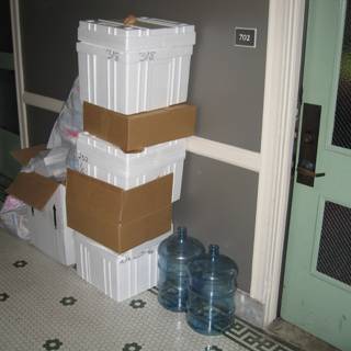 Stack of Boxes and Water Bottle on the Floor