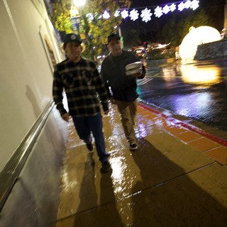 Rainy Night Walk on Illuminated Downtown Street