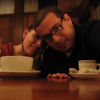 Couple Poses Cheek to Cheek at Restaurant Table