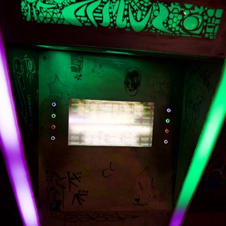 Retro Arcade Cabinet with Glowing Neon Lights