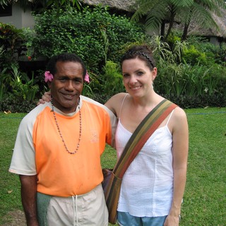Smiling Travelers Pose at Tropical Resort Garden