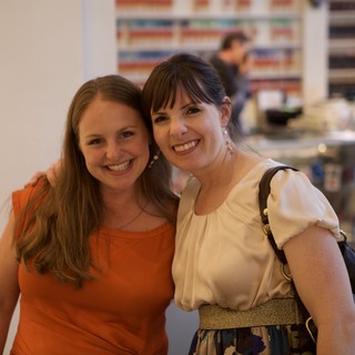 Two Women Smiling Together at Wine Party Event