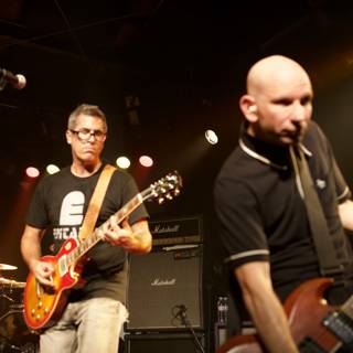 Rocking the Stage: Two Men with Guitars at Bad Religion Concert