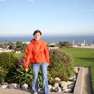 Woman in Orange Jacket Overlooking Coastal California Town