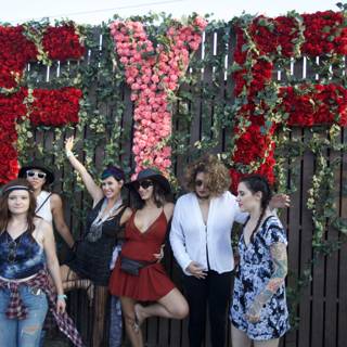 Group Photo in front of Flower Wall