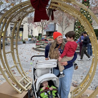 Family Holiday Moment Through Decorative Archway