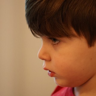 Young Boy in Thoughtful Side Profile Portrait
