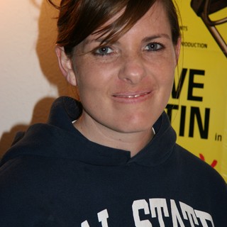 Woman in Cal State Hoodie at Event Backdrop