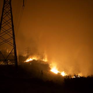 Flames Threaten Power Lines on Hillside
