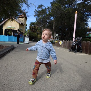 Toddler Exploring Theme Park Path in Denim