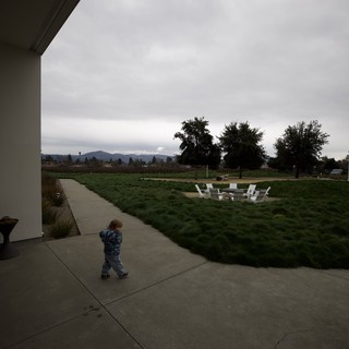 Child Walking Through Modern Patio at Dusk