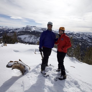 Summit Victory: Couple Atop Snow-Covered Sierra Peak