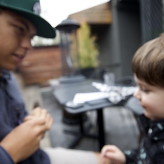 Children Sharing a Warm Moment at Outdoor Café