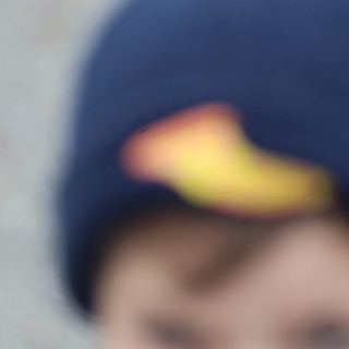 Blurred Close-Up of Child in Navy Baseball Cap