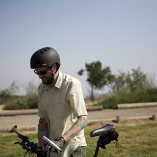 Man on a Bicycle Wearing a Protective Helmet
