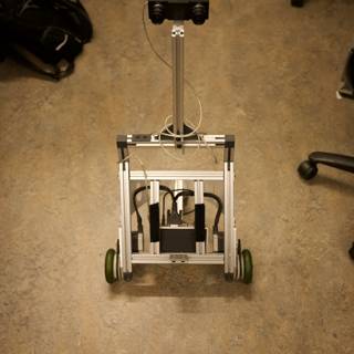 Robot and Computer on Wooden Floor