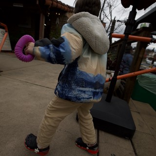 Child Playing on Outdoor Playground Equipment