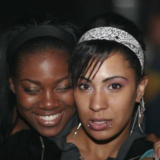 Two Women Flaunting Their Headgear with Smiling Faces