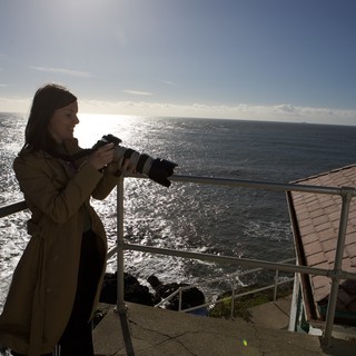 Photographer Capturing the Pacific from Cliff's Edge