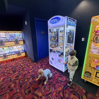 Children Playing at Arcade Claw Machine Area