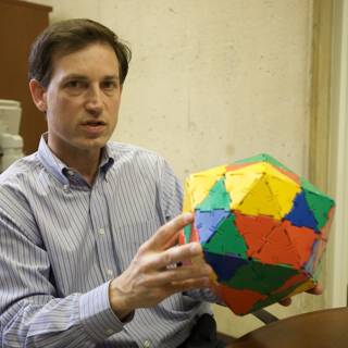 Colorful Sphere in the Hands of a Modern Man