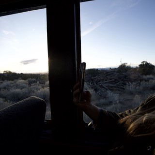 Woman Gazing at Desert Sunset Through Vehicle Window