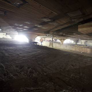 Lone Figure in Dilapidated Underground Room