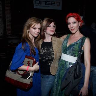 Three Ladies Strike a Pose at a Party