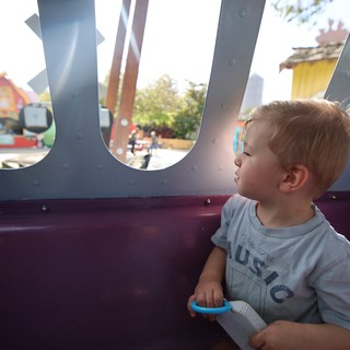 Toddler Gazing Through Playground Portal Window