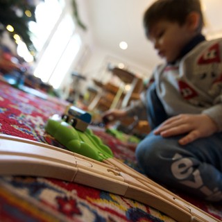 Child Playing with Train Set on Christmas Day