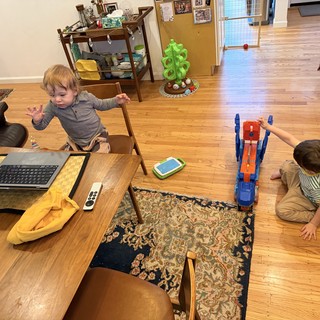 Two Young Children Playing with Toys at Home
