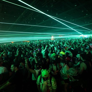 Green Laser Light Show Over Dancing Festival Crowd