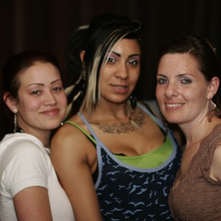 Three Friends Posing at a Nightclub Anniversary Party