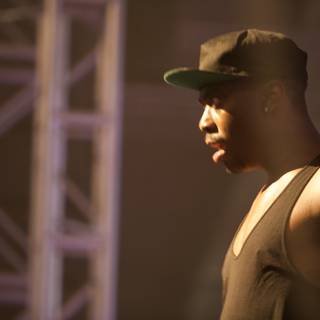 Man in Black Tank Top and Hat Takes the Stage at Coachella 2012