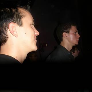 Two men in a dark club room